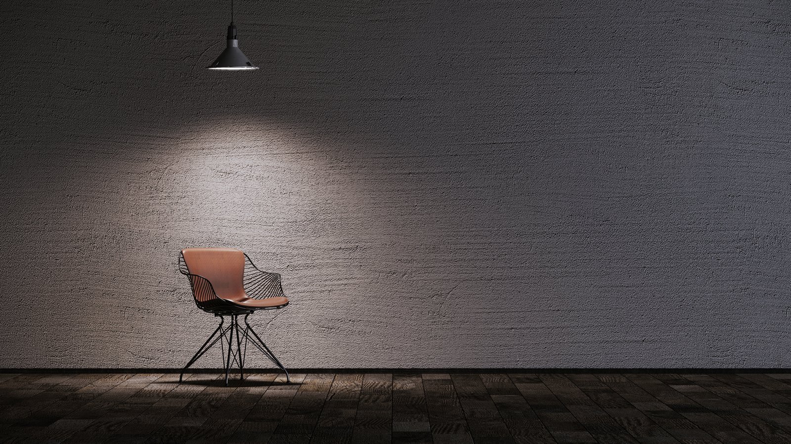 A single chair illuminated in a dark, intimate studio